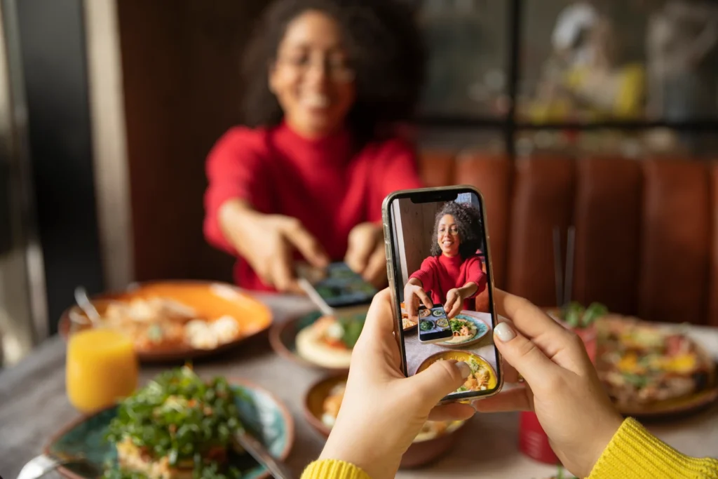 Restraunt owner taking food photos to post on social media